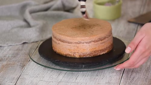 Chocolate Icing Applied To Delicious Layer Cake