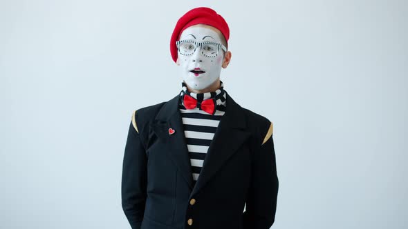 Slow Motion of Happy Mime in Colorful Costume Waving Hand Saying Hi ...