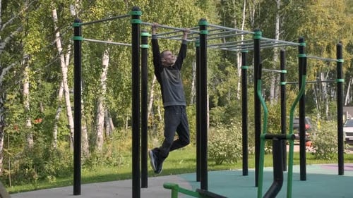 Man Doing Pullups on a Horizontal Bar Outdoors