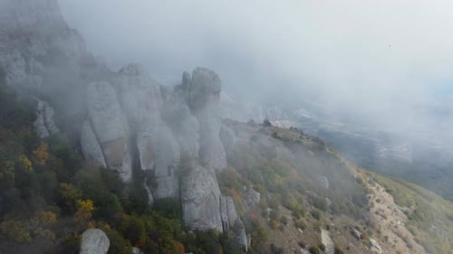 Mountains with Rocky Sculptures That are Getting Covered By Clouds