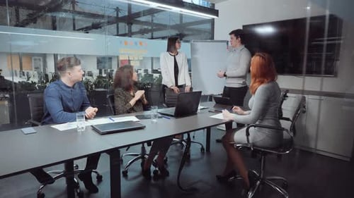 Business Partners Shaking Hands After Making Deal in Office
