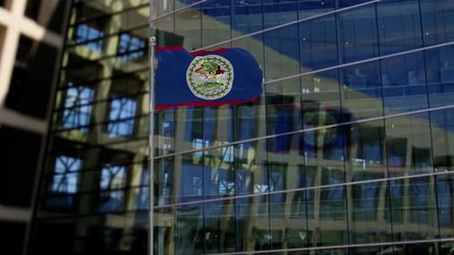 Belize-Flagge weht auf einem Wolkenkratzer-Gebäude