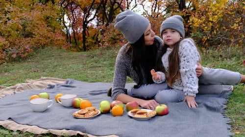 Mom and Threeyearold Daughter in the Park on a Picnic