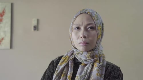 Woman in Headscarf Looks Directly at Camera