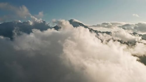 Flying Through Heavenly Beautiful Sunny Cloudscape with Mountain Background