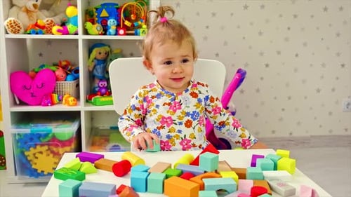 Cute Infant Playing with Colorful Wooden Blocks
