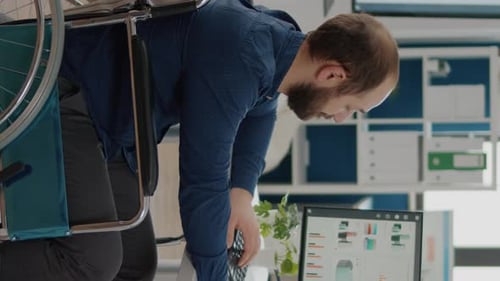 Man in Wheelchair Works in Modern Office