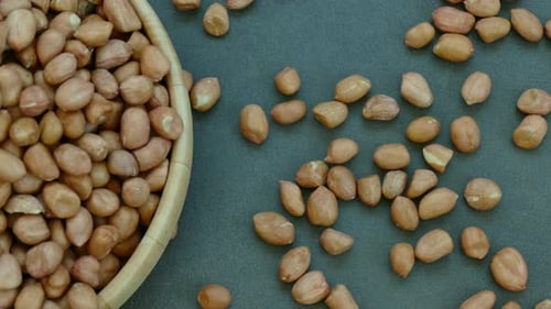 Peanuts in Wooden Bowl on Grey Surface