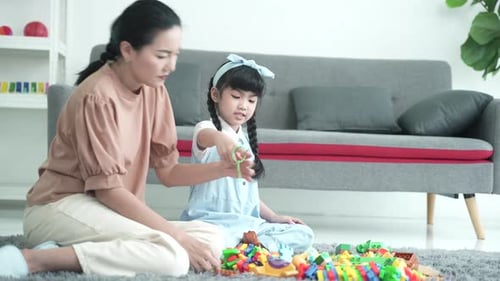 Mother and Daughter Playing with Toy Blocks at Home