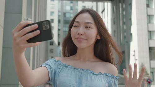 Young Woman Records Selfie Video on Phone Outdoors