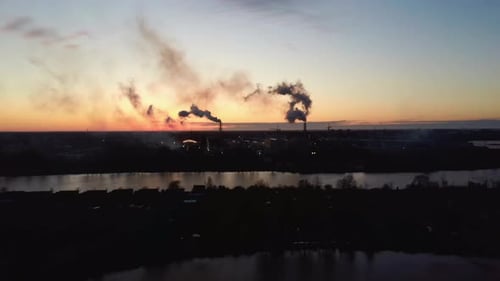 Smoking Stack in Sunrise. Air Pollution and Climate Change Theme. Poor Environment in the City