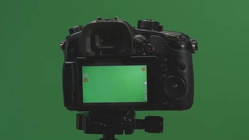 Male Hand Recording Video With Green Screen Display Camera In Green Background