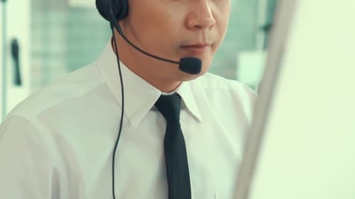 Businessman Wearing Headset Working Actively in Office