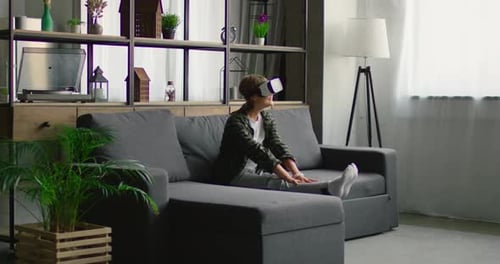 Woman Enjoys Virtual Reality Experience on Couch