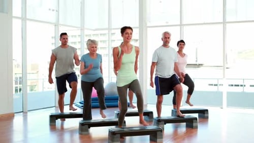 Step Aerobics Class in a Bright Gym