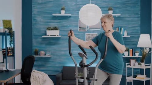 Senior Woman Working Out on Elliptical Machine