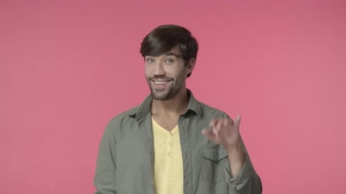 Man Smiling and Waving Hand in Greeting