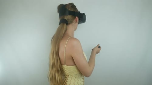 Woman Experiencing Virtual Reality with Headset and Controller