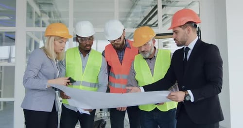 Team of Specialists of Building Company Revisioning Building Plan