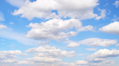 Fluffy Clouds Drifting in a Sunny Blue Sky