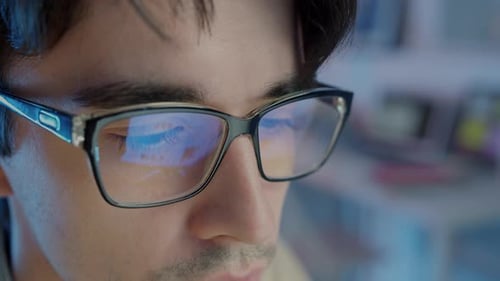 Closeup of Handsome Young Man's Face Indoors in Dark Office