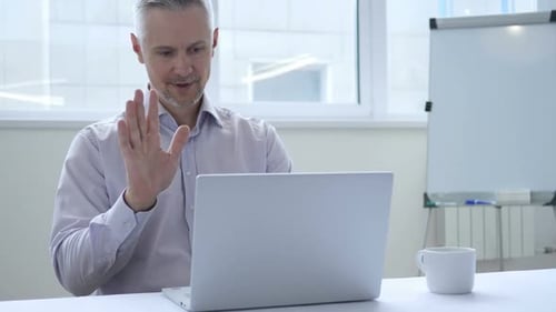 Online Video Chat with Customer on Laptop at Work