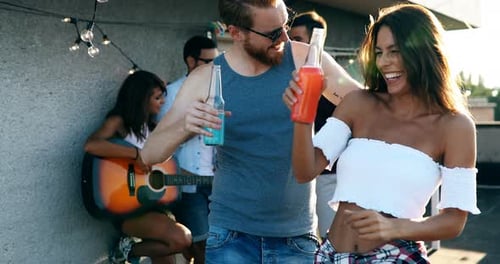 Friends Dancing at Rooftop Party on Sunny Day