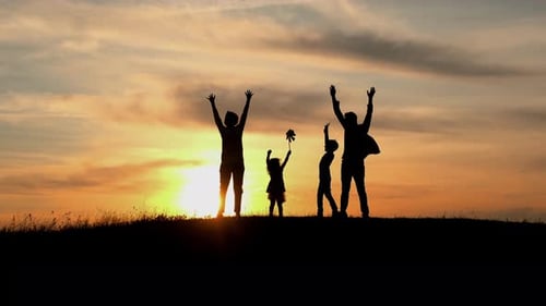 Family Vacation In Nature. Young Mom, Dad And Their Daughters And Son Meet At Sunset.