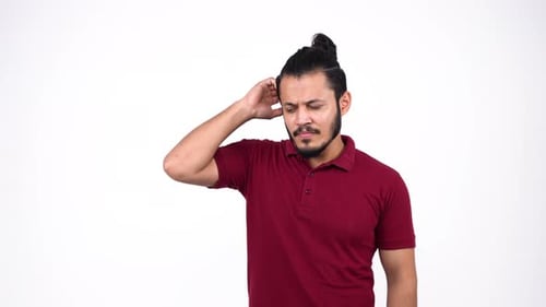 Young Man Scratching Head in Confusion
