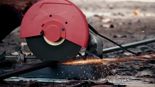 Red Chop Saw Cutting Metal Bar with Sparks