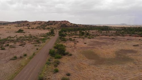 Drone Descent over a District Road on a Cloudy Overcast Day