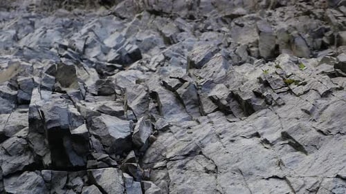 Old Dark Rocks With Sharp Edges From Water Erosion