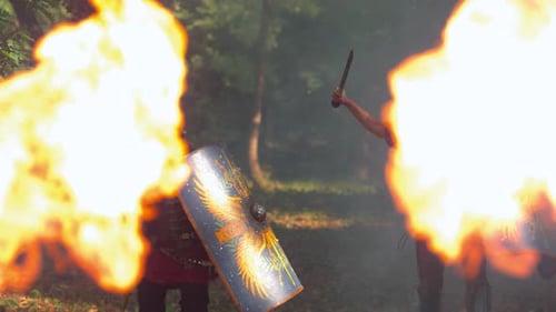 Roman Soldiers with Swords Shields near Flames in Forest