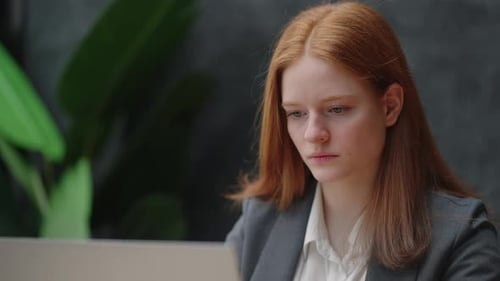 Young Woman Works on Laptop in Corporate Office