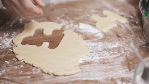Hands Cut Cookies with Cookie Cutters on Table