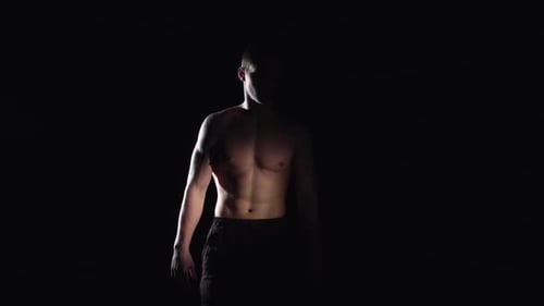 Muscular Man in Dark Setting