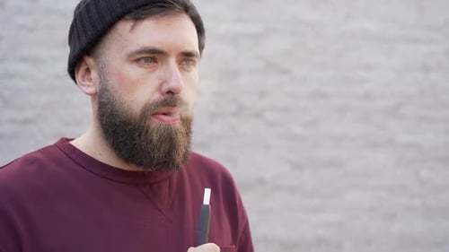 Bearded Man Smoking Electronic Cigarette Outside