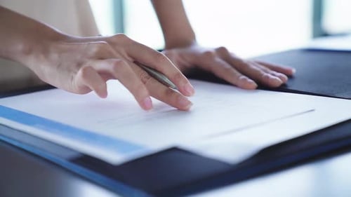 slow motion Mid section of a young asian businesswoman writing, signing documents,contract office ba