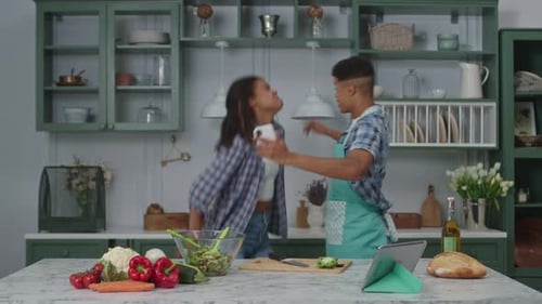 Excited Friends Celebrate Cooking News in Kitchen