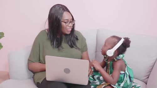 Mother and Child Using Laptop Together at Home