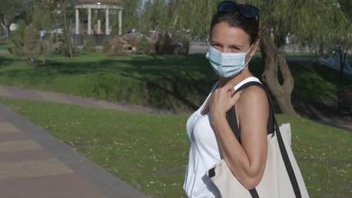 Woman in a mask in the park.