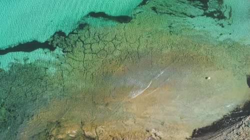 Transparent sea water near stony remote coast