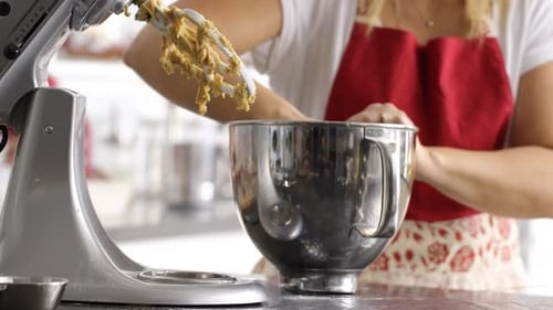 Scooping dough out of electric mixer