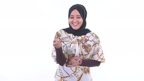 Smiling Woman Points to Camera on White Background