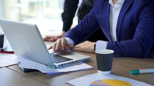 Mann tippt im Büro auf Laptop. Geschäftsmann arbeitet im Home-Office am Laptop