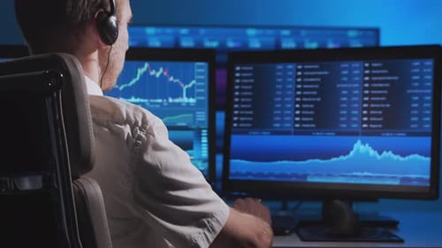 Broker works in office using workstation and analysis technology. Workplace of trader.