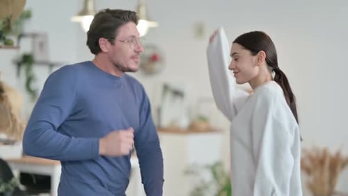 Couple Dancing Together Joyfully in Home Interior