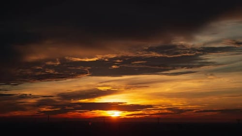 Sunset cloudy sky time lapse on downtown cityscape building in the evening