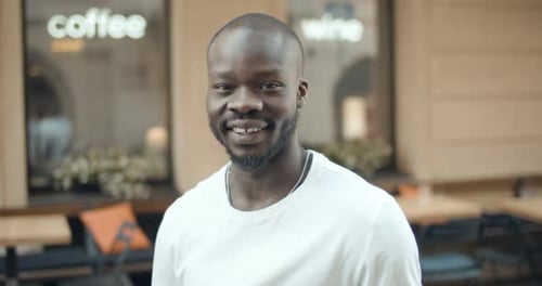 Smiling Man Standing on City Street