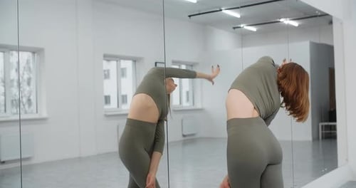 Dancer Warms Infront of the Mirror Wall at the White Bright Dance Hall Ballet Rehearsal Ballerina